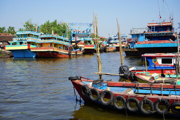 A wooden fishing boat is parked at the mouth of the Juwana River, Pati, Central Java, Indonesia.
