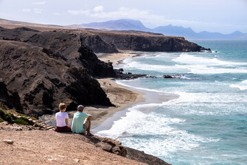 A couple looking out over the beach at La Pared on the west coast of the Canary Island of...