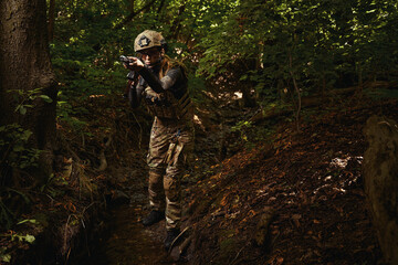 Woman performing task in extreme conditions in forest