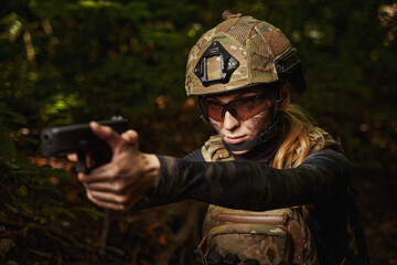 Female person in helmet aiming at target