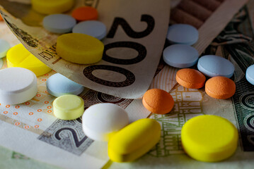 Obraz na płótnie Canvas Drugs scattered on the money. Color, horizontal photo.