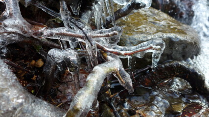 Beautiful icicles on a frozen mountain stream