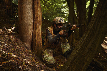 Soldier sitting and holding firearms for shooting