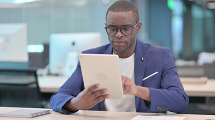 Young African Businessman using Tablet in Office