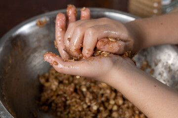 Liittle girl hands preparing oatmeal chocolate chips cookies