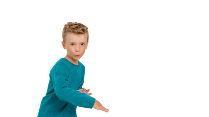 The little boy is celebrating and dancing. Child dressed in birch long sleeve, white isolated background, studio portrait
