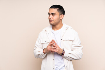 Asian handsome man over isolated background scheming something