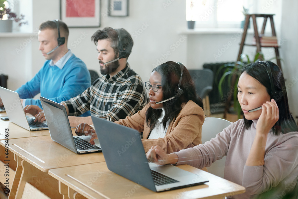 Poster multiracial operators sitting by desk in office during online consultation