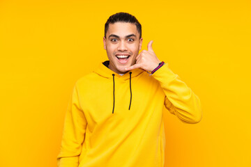 Asian handsome man isolated on yellow background coughing a lot