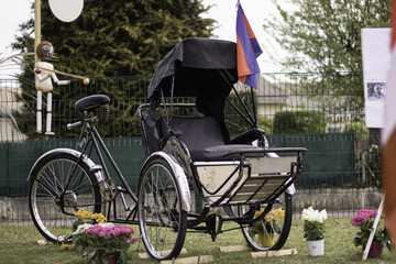Selective focus shot of a beautiful Rickshaw with a flag