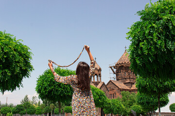 A girls scarf is playing with the wind