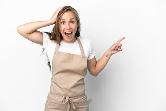 Restaurant waiter caucasian woman isolated on white background surprised and pointing finger to the side