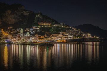 Wide panoramic view of Amalfi at night, Campania region, Italy.
