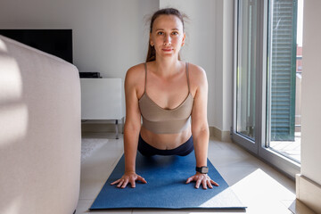 Upward facing dog yoga pose close up image of young woman