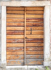 Old wooden doors of stone house. Close up.