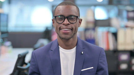 Obraz premium Portrait of Young African Businessman Smiling at Camera