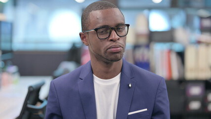 Fototapeta premium Portrait of No Sign by Young African Businessman by Finger Shake