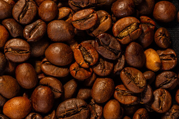 Natural background for Cafe menu or brochure template - macro photo of brown roasted coffee beans, close up
