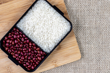 White rice and red beans on the wooden table in Brazil