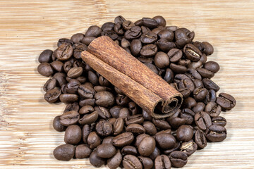 cinnamon sticks on the coffee roasted beans background in Brazil