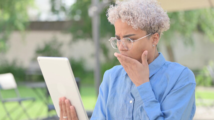 Portrait of African Woman Upset by Loss on Tablet 