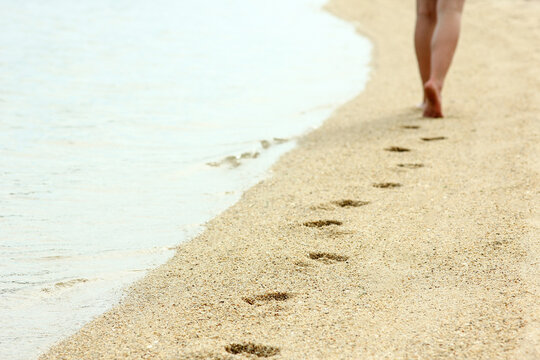 footprints in the sand on the beach