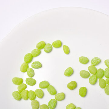 Green Jelly Beans On A White Plate