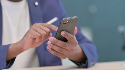 Hands Close up of Young African Businessman using Smartphone