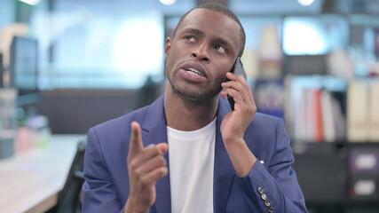 Portrait of Young African Businessman Talking on Phone