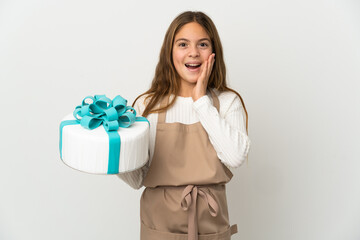 Little girl holding a big cake over isolated white background with surprise and shocked facial expression