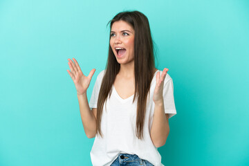 Young caucasian woman isolated on blue background with surprise facial expression