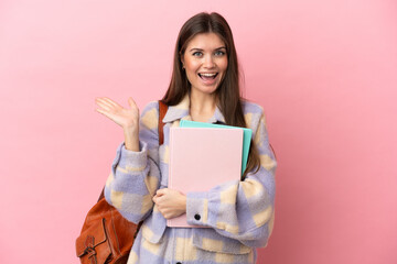 Young student woman isolated on pink background with shocked facial expression