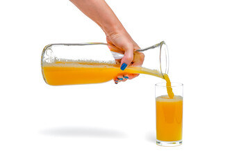 Orange juice isolate. A woman pours orange juice into a glass. Juice filling process on white...