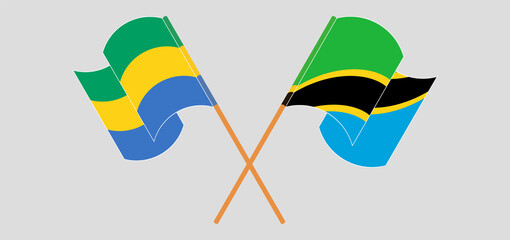 Crossed and waving flags of Gabon and Tanzania