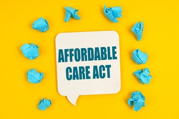 On a yellow background, blue pieces of paper and a sign with the inscription - Affordable Care Act