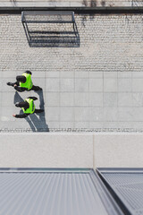Top view of two cops patrolling city streets wearing black uniforms and vests