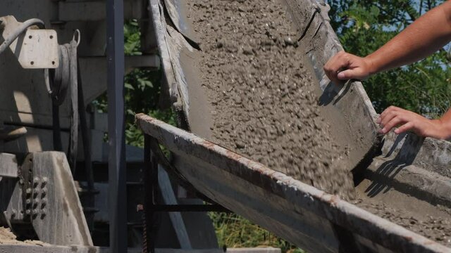 Foreman controls the flow of liquid concrete in the chute