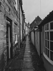 narrow street in the town with no one in sight but windows and doors