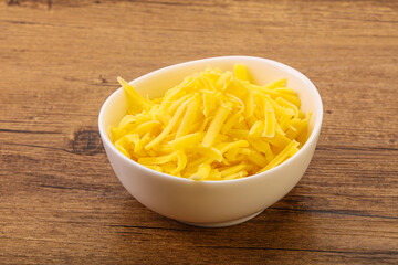 Shredded yellow cheese in the bowl
