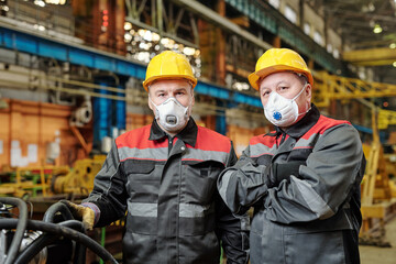 Two engineers in masks at work