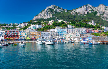 Fototapeta na wymiar CAPRI, ITALY - JUNE 18, 2021: Famous port of Capri on a sunny beautiful day.