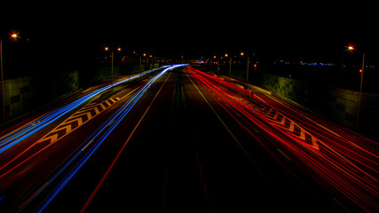 Fototapeta na wymiar night highway, long exposure of cars lights on the night road