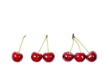 Obraz na płótnie Canvas One, two and three Ripe red sweet cherry isolated on white background. Macro photo close up