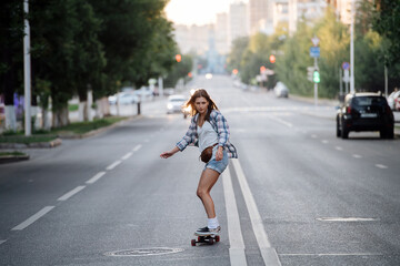 Impressive woman riding on a skateboard on an long beutiful empty city road