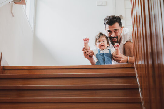 little toddler children with first walk step with stairs at home, small baby person are happy to play and learn to crawling with family, cute infant boy having fun and childhood care