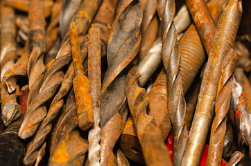 Closeup of many rusty metal drill bits 