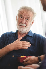 caucasian man surprise him adult father with giving gift box to celebration at home, family present to happy together lifestyle with love, people having fun and smiling in holiday