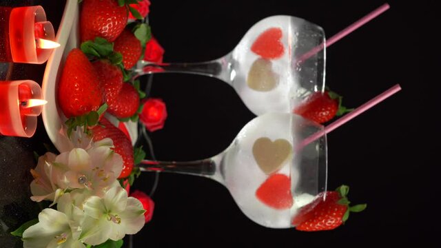 Large cocktail glasses with straw Valentine's Day composition, 4k vertical video