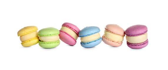 Many delicious colorful macarons on white background
