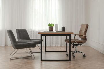 Director's office with large wooden table and comfortable armchairs. Interior design